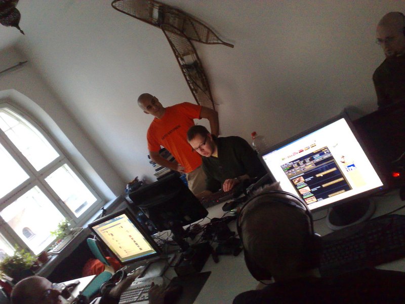 Players at their stations during a late-night session in the low-lit hall